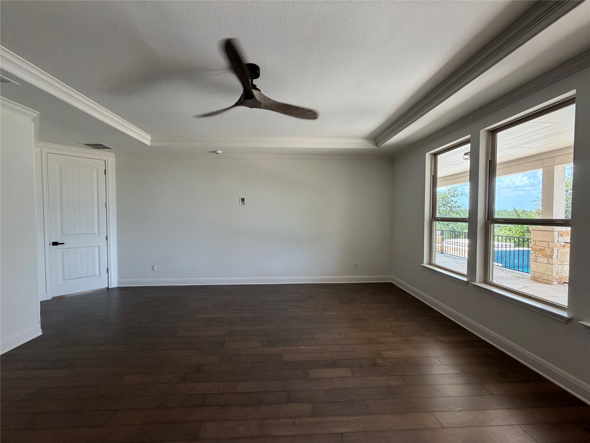 7801 Aria Loop Austin, TX 78736 - Photo 14 of 40 Primary Suite on Main Level with stylish wood panel details Overlooks the Backyard