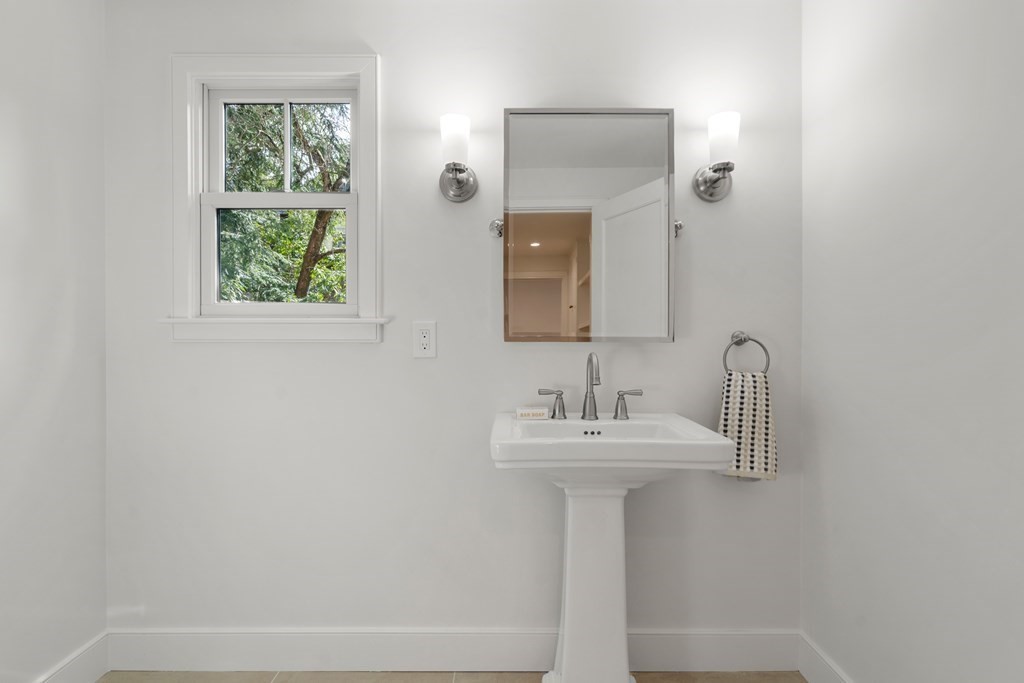 28 Tyler Road Belmont, MA 02478 - Photo 6 of 25 a bathroom with a sink a mirror and window