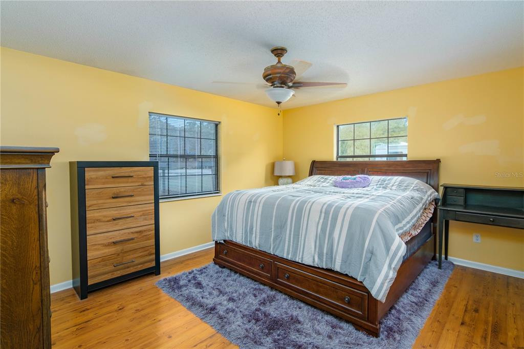 126 Southwest Mockingbird Way Lake City, FL 32024 - Photo 33 of 37 a bedroom with a bed and a walk in closet
