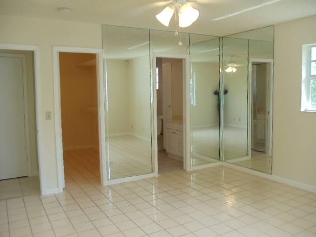 1112 Seagrape Road Lantana, FL 33462 - Photo 11 of 22 a bathroom with a shower and a glass door