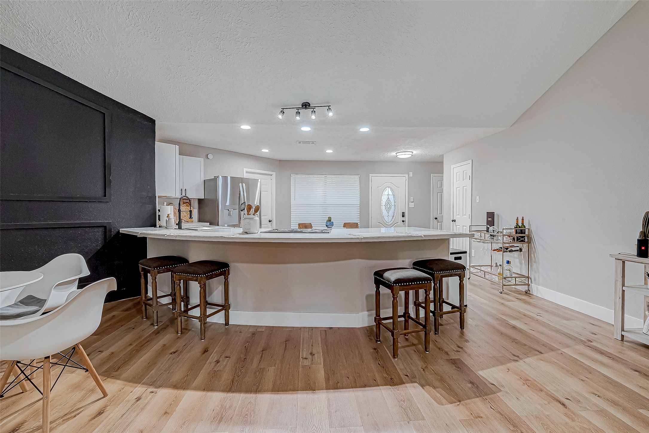 17431 Typhoon Way Crosby, TX 77532 - Photo 12 of 34 a kitchen with a table chairs a sink dishwasher window and cabinets