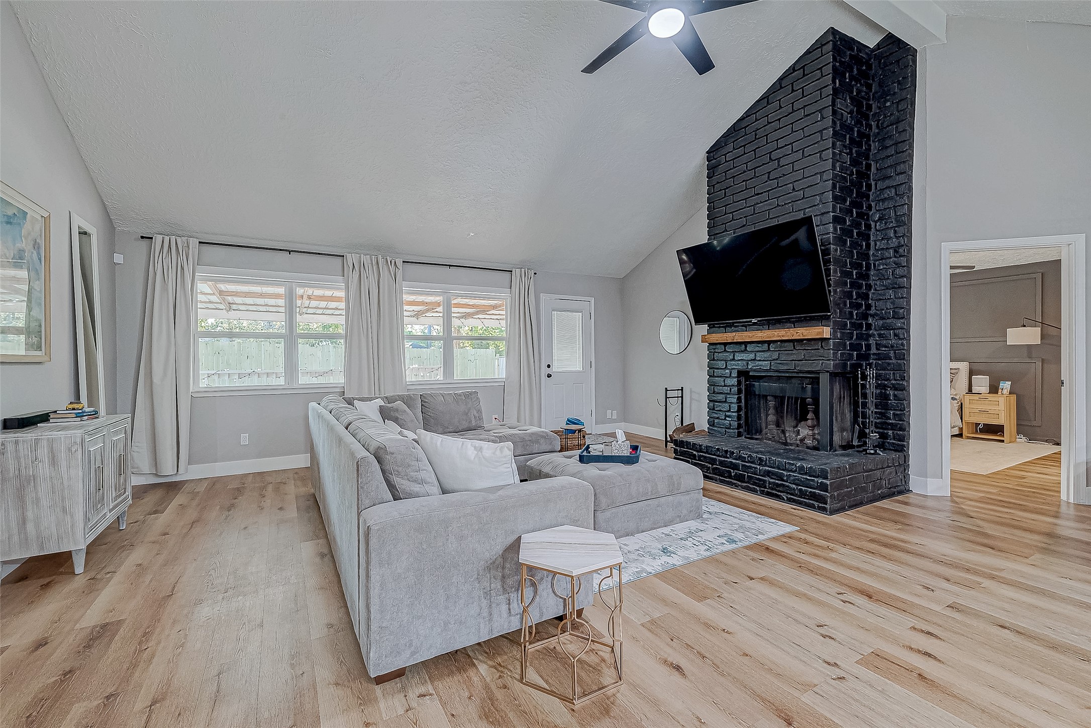 17431 Typhoon Way Crosby, TX 77532 - Photo 15 of 34 a living room with furniture a flat screen tv and a fireplace
