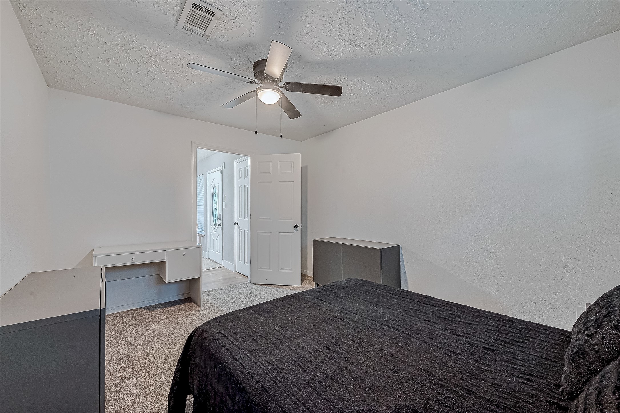 17431 Typhoon Way Crosby, TX 77532 - Photo 24 of 34 a bedroom with a bed and a chandelier