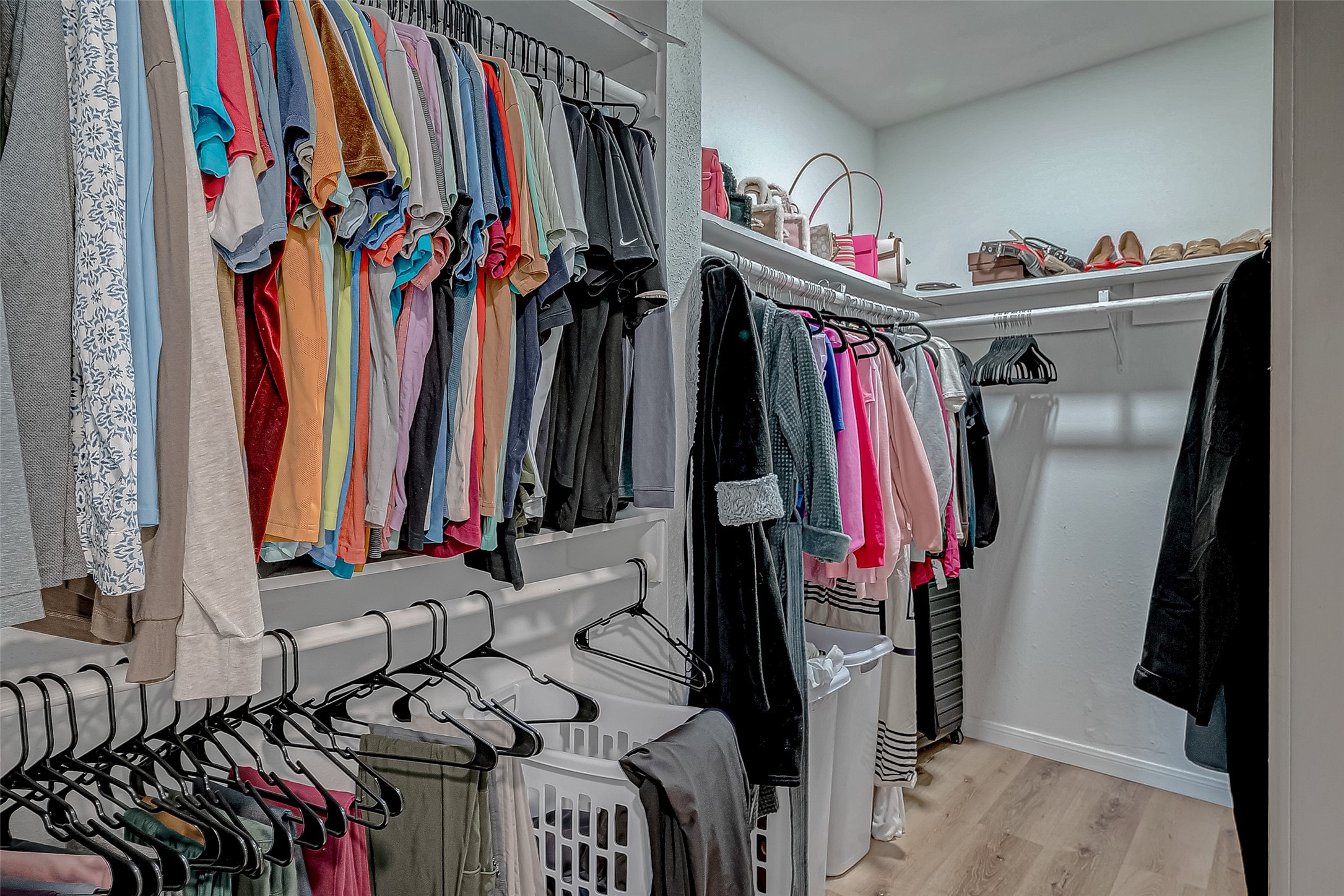 17431 Typhoon Way Crosby, TX 77532 - Photo 30 of 34 a view of walk in closet with clothes