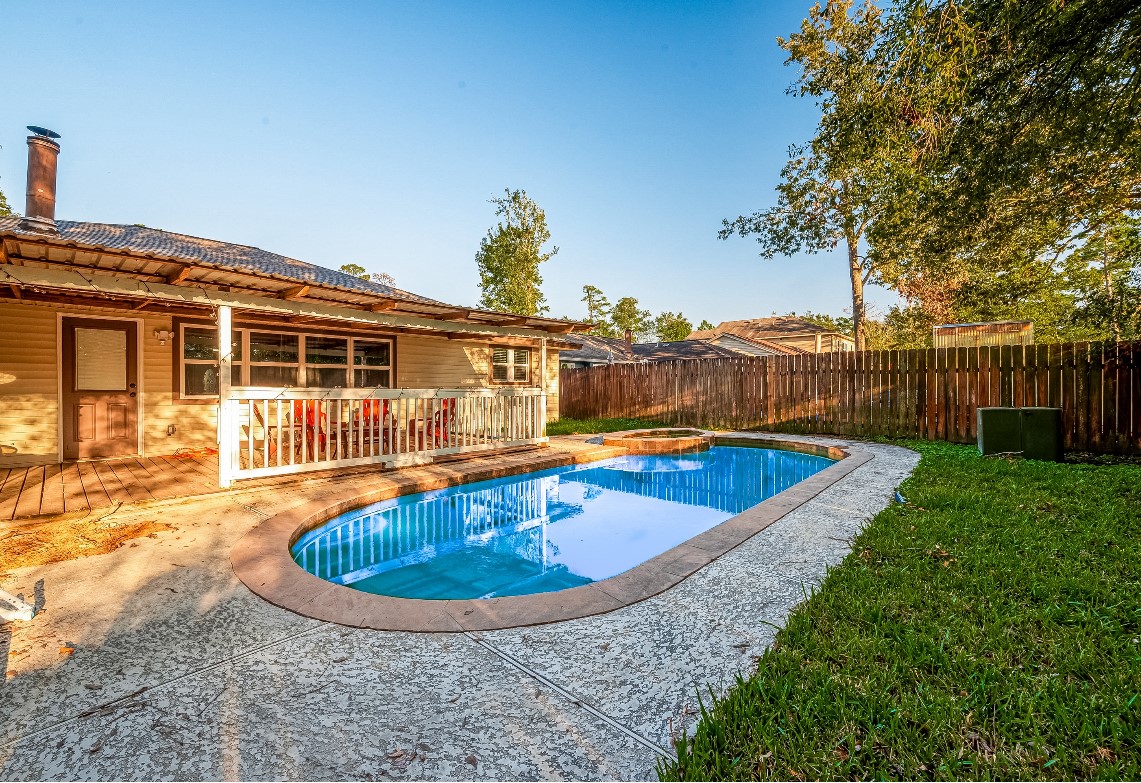 17431 Typhoon Way Crosby, TX 77532 - Photo 34 of 34 a view of a swimming pool with a yard