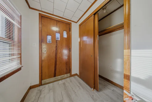 an empty room with windows and cabinet