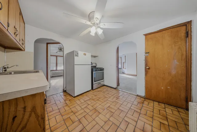 a view of a kitchen with a sink and a refrigerator