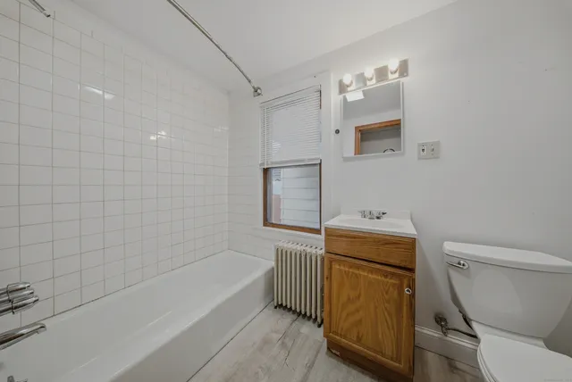 a bathroom with a sink a toilet and bathtub