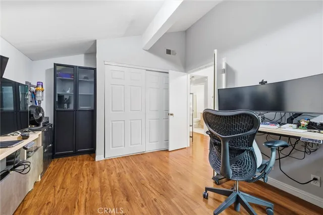 a view of a workspace with furniture and wooden floor