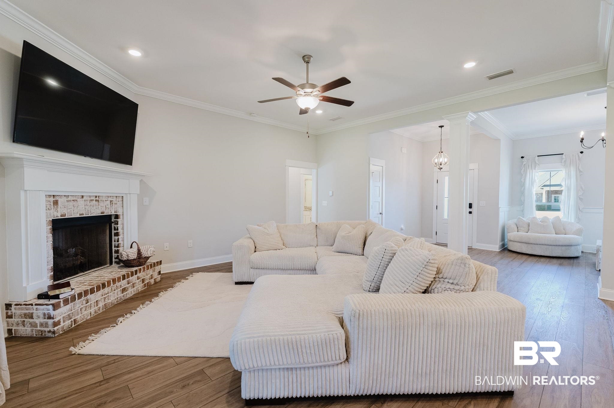7872 Calverton Street Foley, AL 36535 - Photo 33 of 76 Spacious living area featuring wood-finish flooring, a white brick fireplace with a mantel, recessed lighting, and a ceiling fan