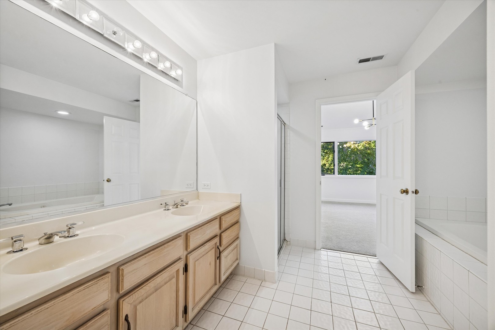 179 Foxborough Place Burr Ridge, IL 60527 - Photo 10 of 18 a spacious bathroom with a shower sink and mirror