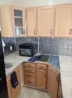 a kitchen with a stove and cabinets