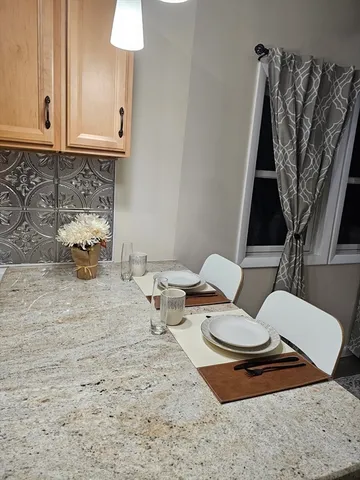 a view of a livingroom with furniture and staircase