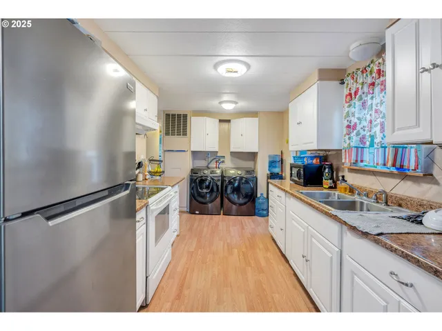 a kitchen with granite countertop lots of counter top space and refrigerator