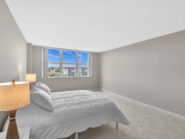 a living room with a bed furniture and a window