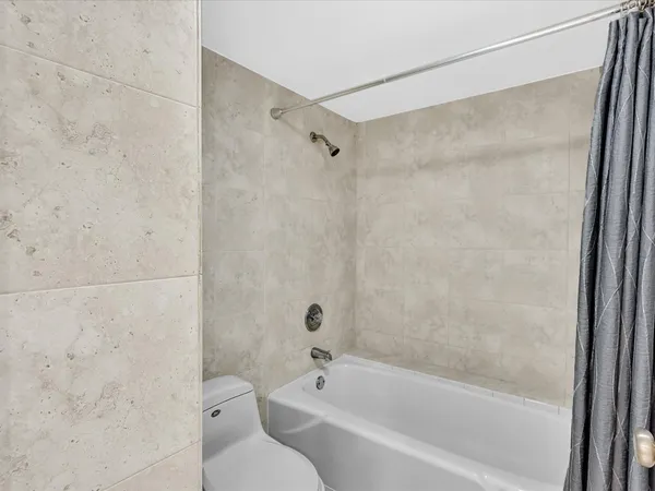 a bathroom with a bathtub and a shower