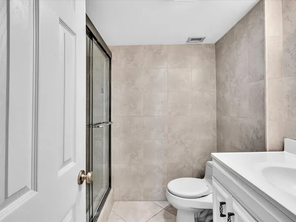 a white toilet sitting next to a bathroom sink
