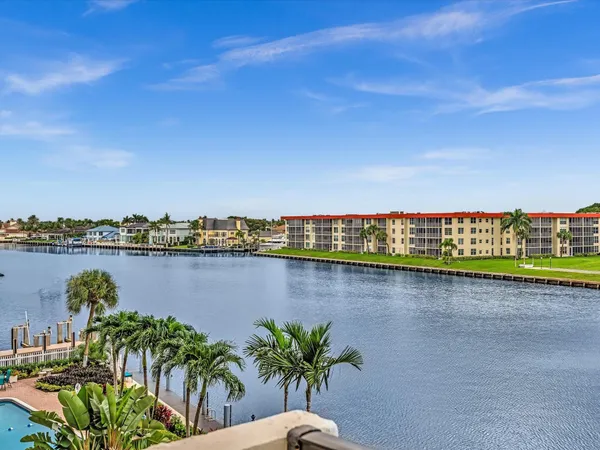 a balcony with couple of potted plants and more windows