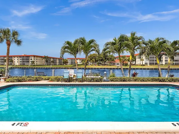 a view of a swimming pool with a table and chairs