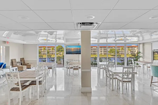 a living room with lots of furniture and view of kitchen