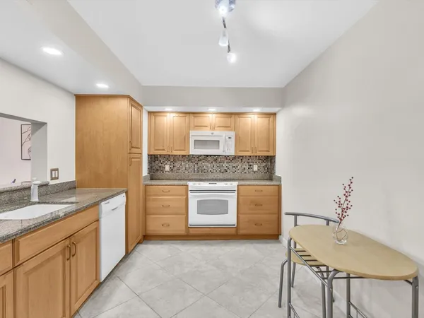 a bathroom with a granite countertop sink mirror and