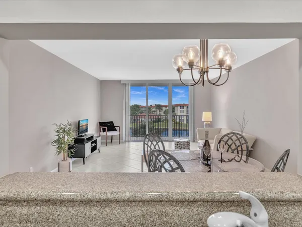 a view of living room with furniture and a floor to ceiling window
