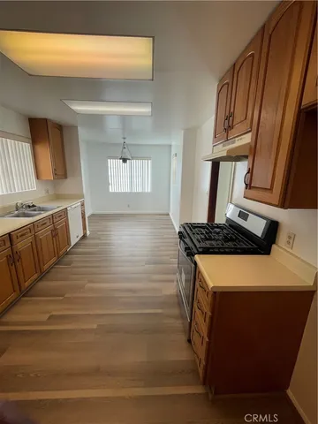 a kitchen with stainless steel appliances granite countertop a stove and a sink