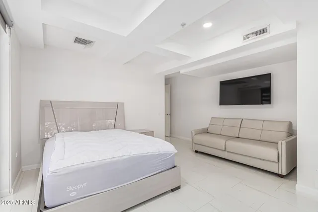 a bathroom with a couch and a flat screen tv