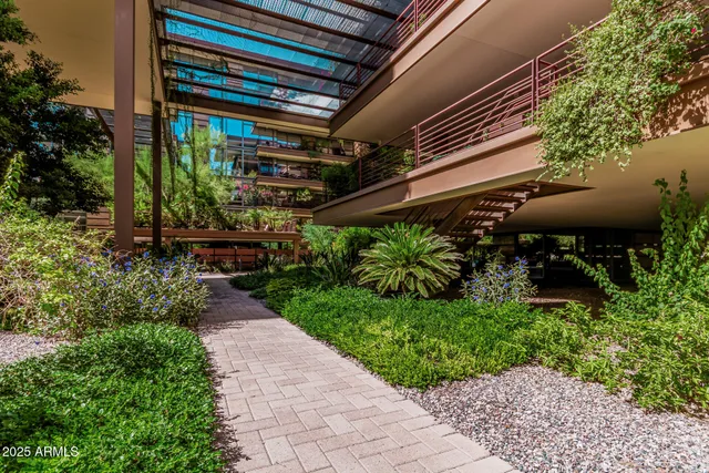 a backyard of a house with a garden and outdoor seating