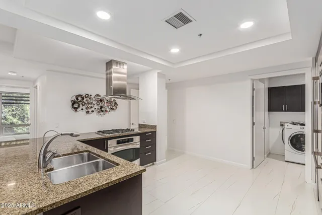 a view of a kitchen with a sink and dishwasher