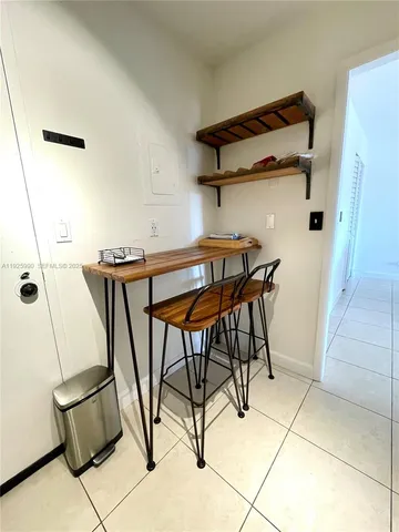 a view of a room with furniture and wooden floor