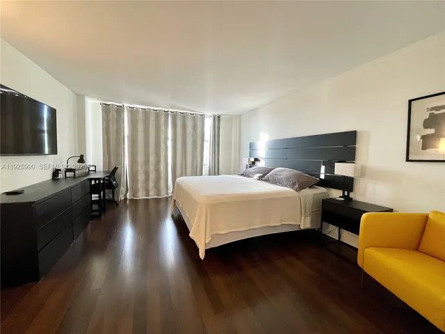 a bedroom with a bed and a couch