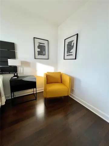 a living room with furniture a flat screen tv and a wall painting