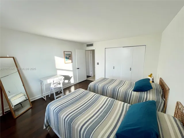 a bedroom with two beds and a couch