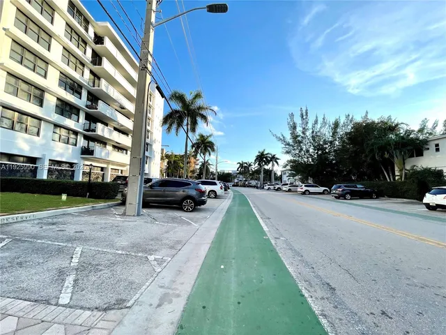 a view of a street with a cars parked in front of it
