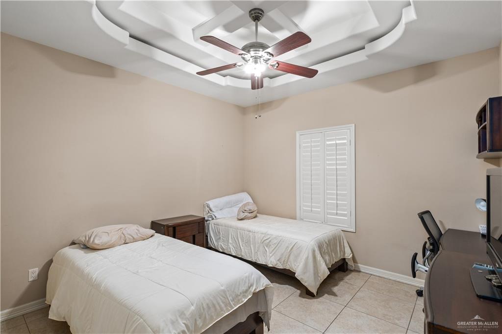 3205 Washington Avenue Mission, TX 78573 - Photo 8 of 16 a bedroom with two beds and a chandelier