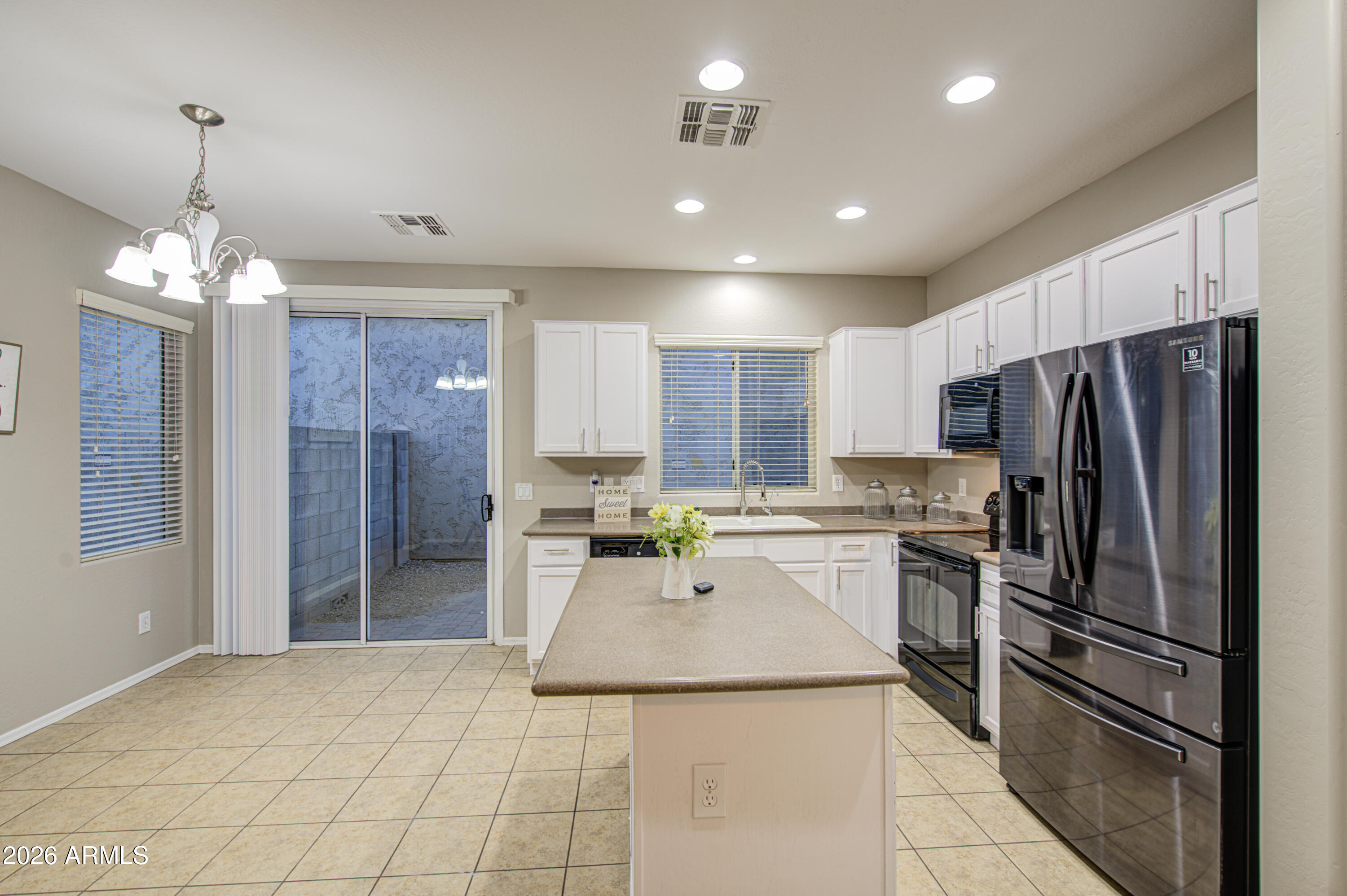 7759 West Monte Vista Road Phoenix, AZ 85035 - Photo 16 of 43 a kitchen with refrigerator and cabinets