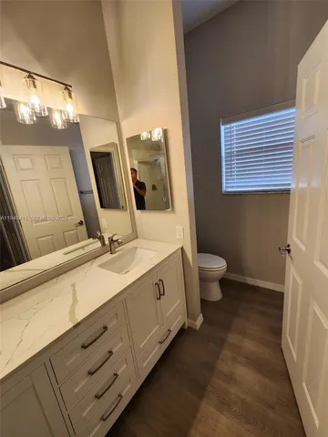 a spacious bathroom with a double vanity sink toilet and a tub