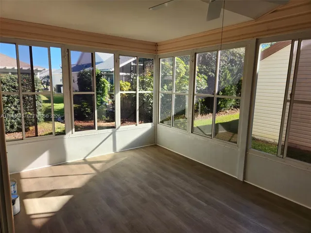a view of porch with a floor to ceiling window and wooden floor