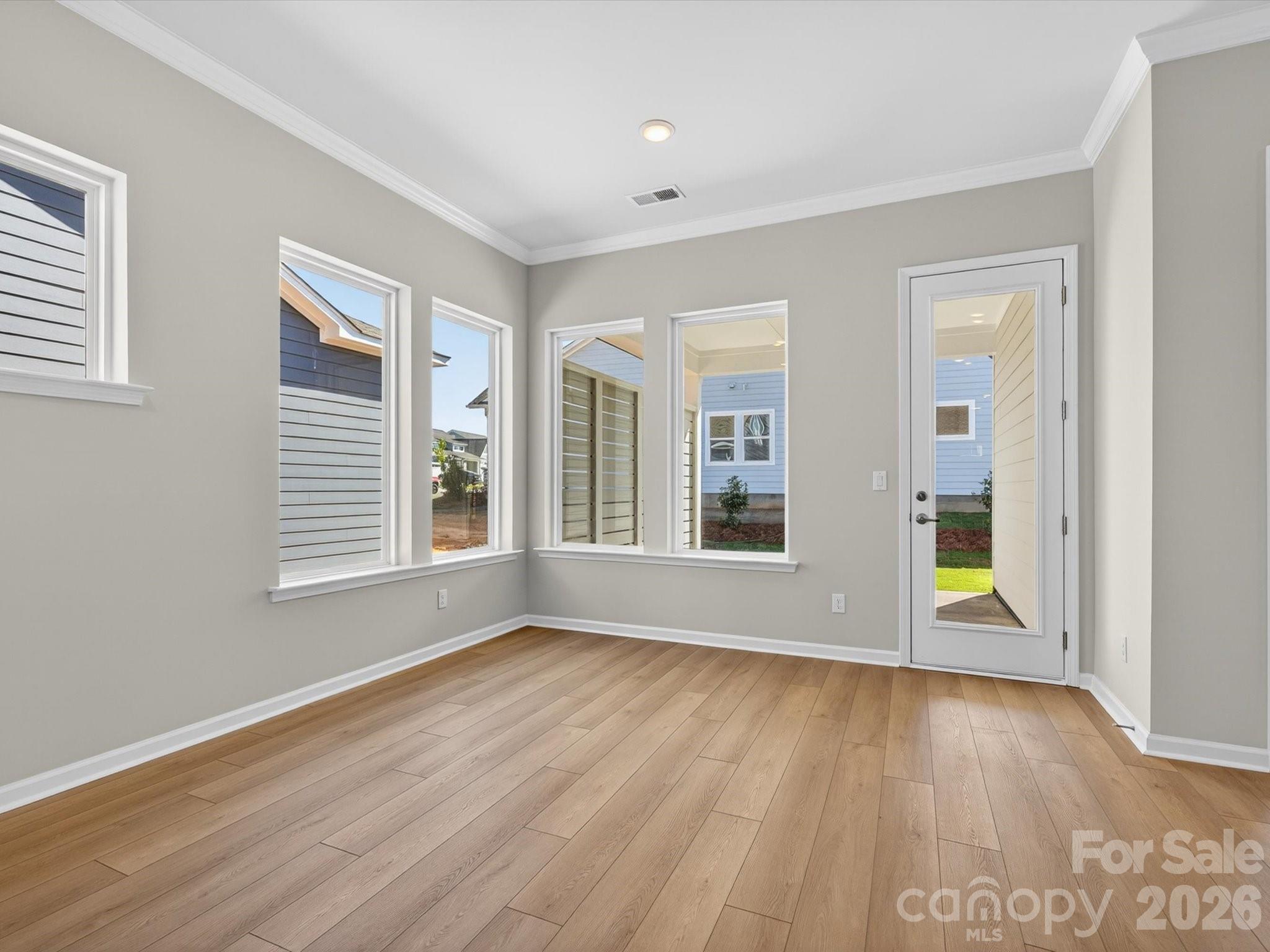 1007 Meander Lane Waxhaw, NC 28173 - Photo 11 of 35 a view of an empty room with wooden floor and a window