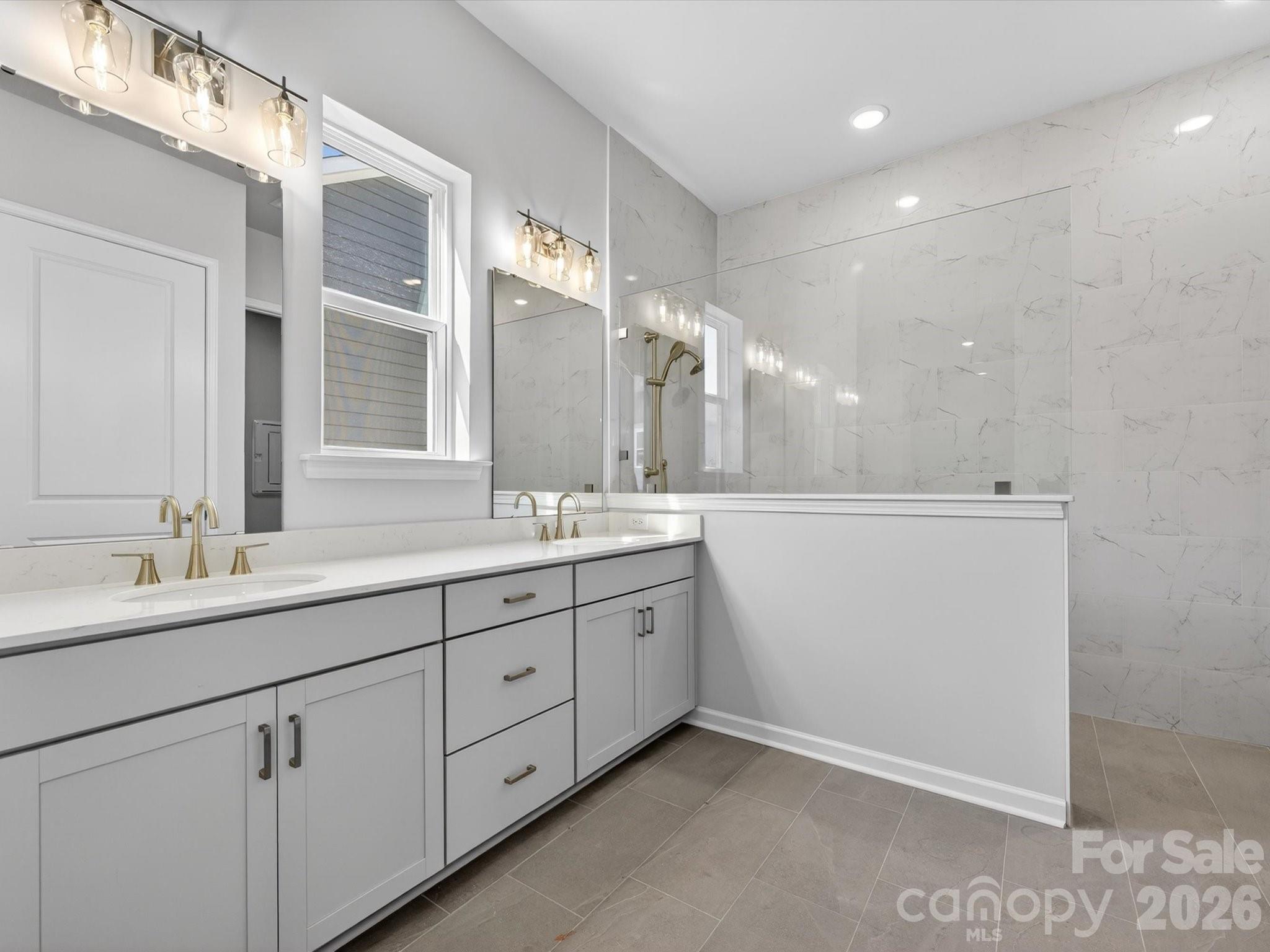 1007 Meander Lane Waxhaw, NC 28173 - Photo 16 of 35 a bathroom with a double vanity sink and mirror