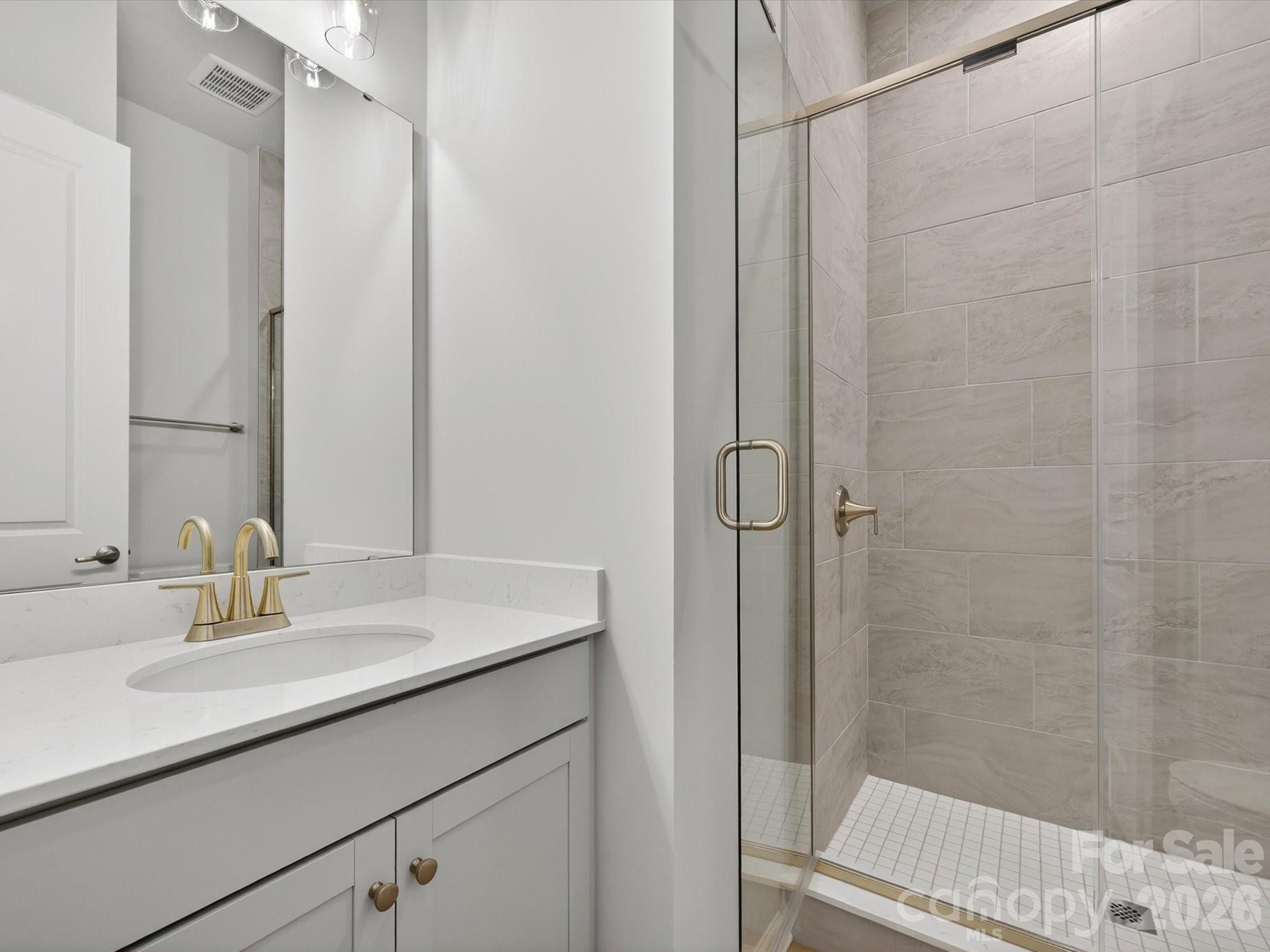 1007 Meander Lane Waxhaw, NC 28173 - Photo 3 of 35 a bathroom with a sink and a mirror