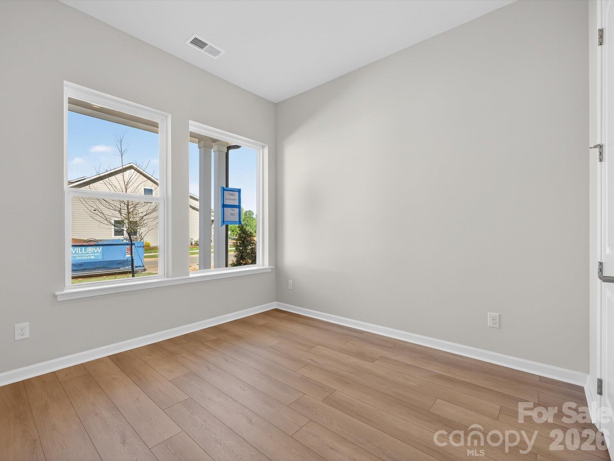 1007 Meander Lane Waxhaw, NC 28173 - Photo 4 of 35 a view of an empty room with wooden floor and a window