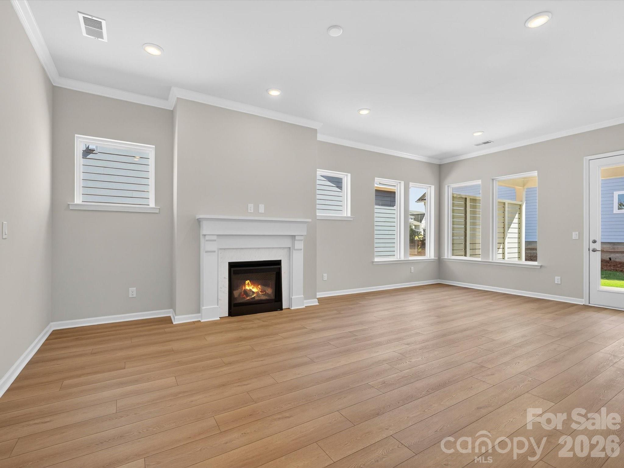1007 Meander Lane Waxhaw, NC 28173 - Photo 9 of 35 a view of empty room with wooden floor and fireplace