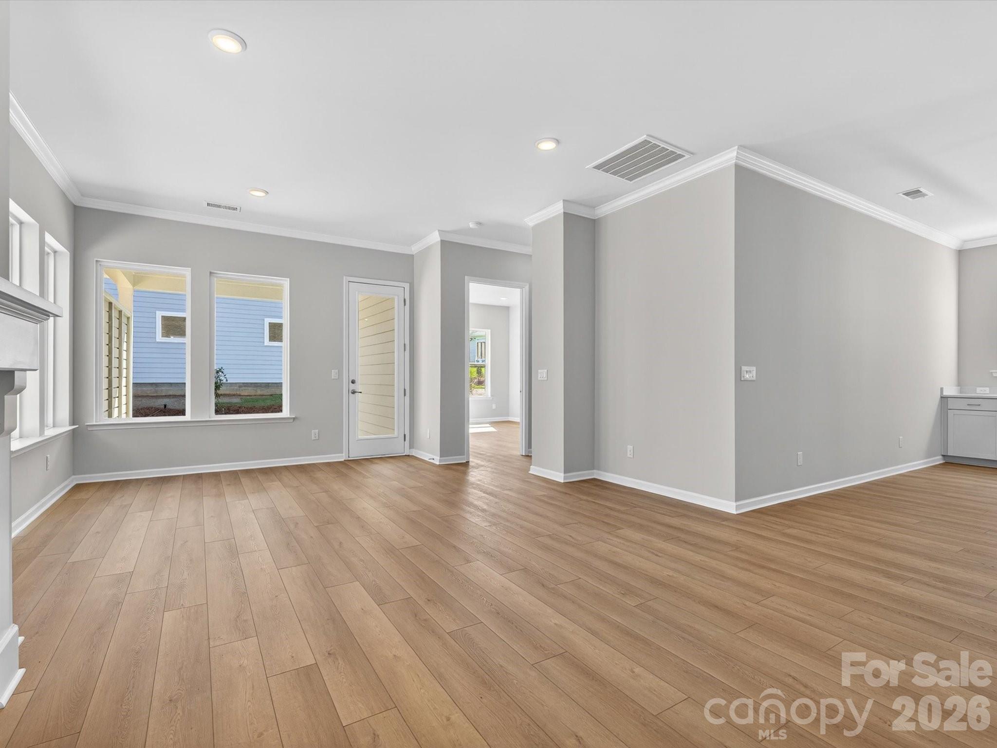 1007 Meander Lane Waxhaw, NC 28173 - Photo 10 of 35 a view of an empty room with wooden floor and a window