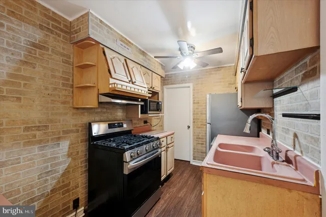 a kitchen with stainless steel appliances granite countertop a stove and a sink