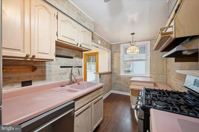 a kitchen with a sink appliances and cabinets