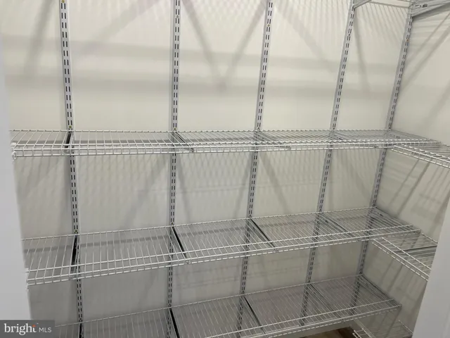 a kitchen with kitchen island stainless steel appliances a stove top oven a sink dishwasher a refrigerator and a dining table with wooden floor