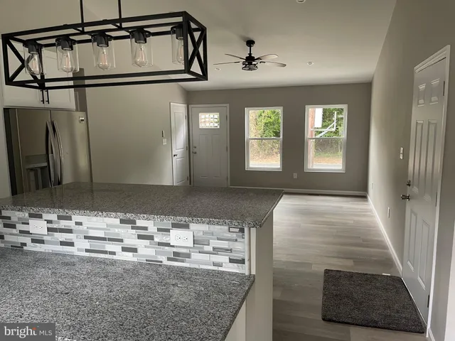 a view of livingroom with hardwood floor and ceiling fan