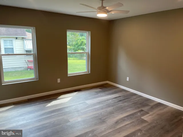 an empty room with closet and a window